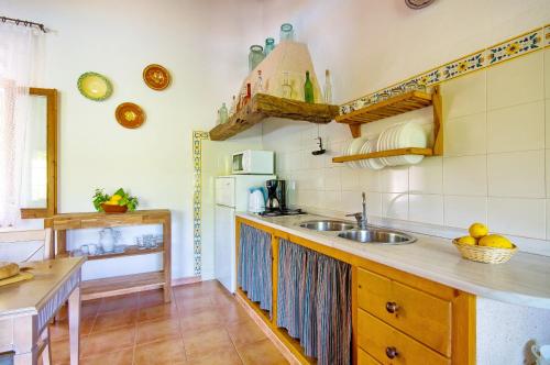 a kitchen with a sink and a counter top at Na Garrovera in Pollença