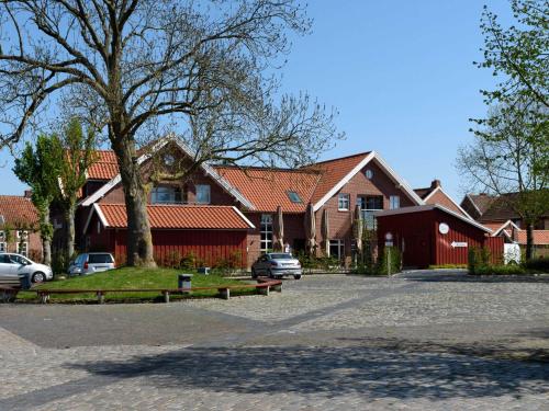 a large house with cars parked in front of it at Sielhof Ditzum, 45222 in Ditzum