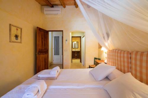 a bedroom with a bed with two towels on it at Son Reus in Felanitx