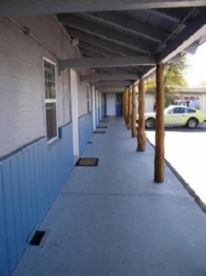 an empty hallway of a building with a car parked at Hacienda Motel in Alturas