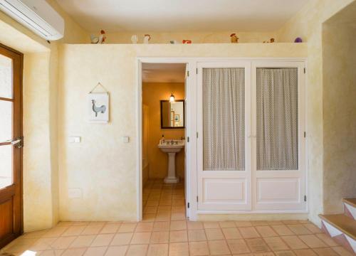 a bathroom with a white door and a sink at Son Reus in Felanitx
