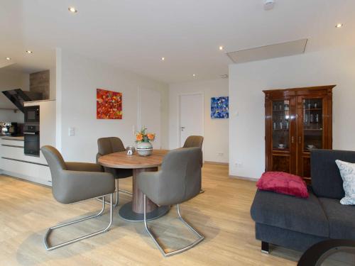 a living room with a table and chairs and a couch at Sielhof Ditzum, 45222 in Ditzum
