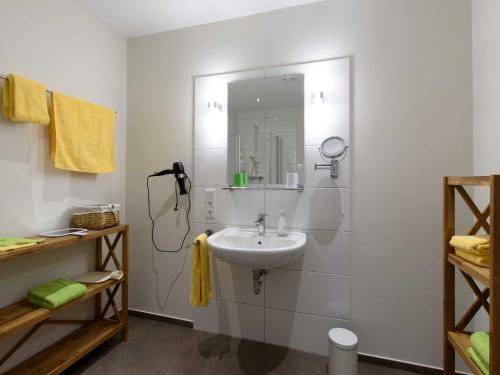 a bathroom with a sink and a mirror on the wall at Sielhof Ditzum, 45222 in Ditzum