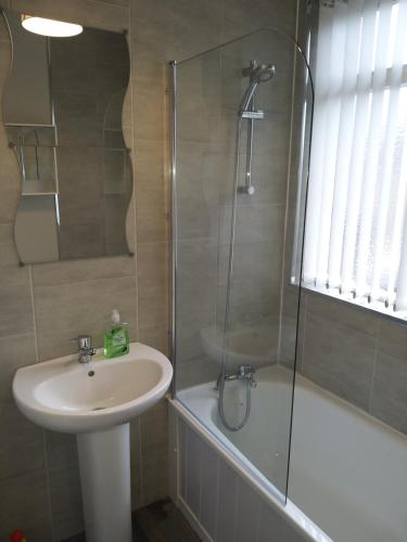 a bathroom with a sink and a shower at Templemore Townhouse in Belfast