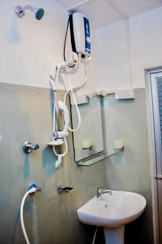 a bathroom with a sink and a mirror at Star Light Cabanas & Restaurant in Tangalle