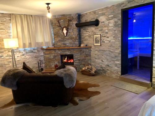 a living room with a couch and a fireplace at Luxus Spa auf tollem Anwesen in Neubulach