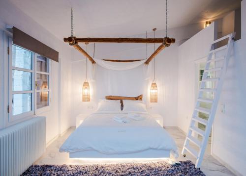 a bedroom with a bed and a ladder at Blue Mountain Guesthouse by Seablue in Arachova