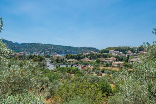 a view of a city from a hill with trees at Dos Villas in Sóller