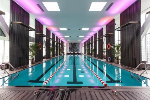 a large swimming pool in a building at Hotel MoMc in Beijing