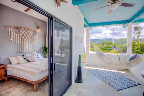 a bedroom with a swinging bed and a hammock at Sayulita Boutique Suites - Pool Access, Kitchen, Walk to Beach in Sayulita