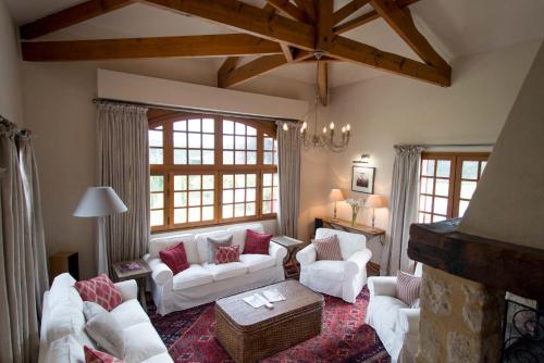 a living room with white furniture and large windows at La Maison in Villeneuve-de-Duras
