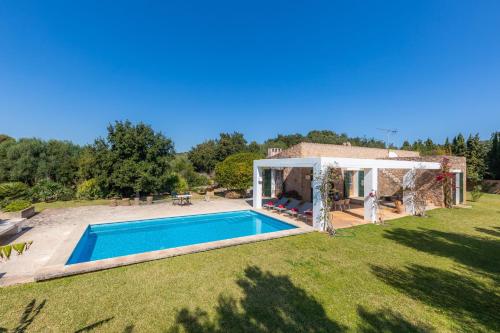 an external view of a villa with a swimming pool at Sa Plana in Son Servera