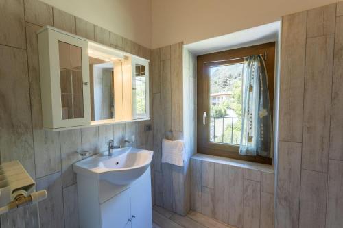 a bathroom with a sink and a window at Appartamento Ginevra in Tremosine Sul Garda