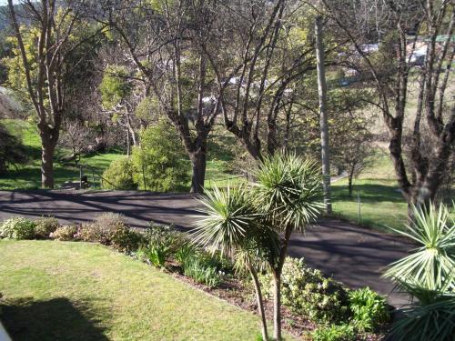 a park with trees and plants and a sidewalk at Lucinda B&B in Latrobe