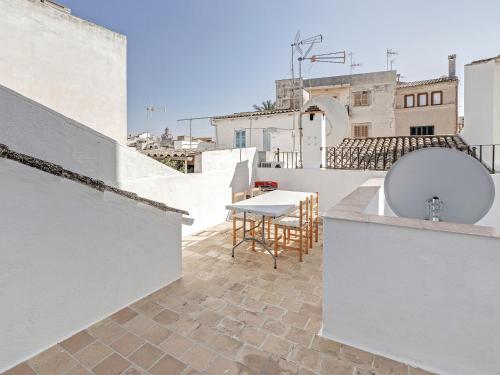 a balcony with a table on the roof of a building at Casa Convent in Alcudia