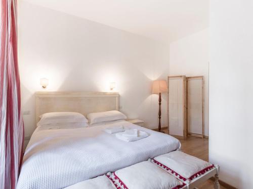 a white bedroom with two beds and a lamp at Wonderful Villa Botticelli in Cavaion Veronese