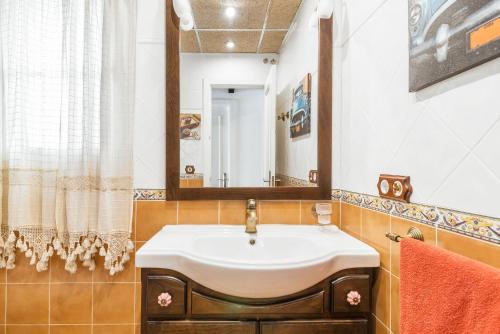 un baño con lavabo y espejo en Villa Marty - Mayores De 25 Años, en Chiclana de la Frontera