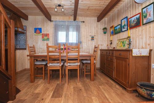 a dining room with a wooden table and chairs at Imasaru in Roche