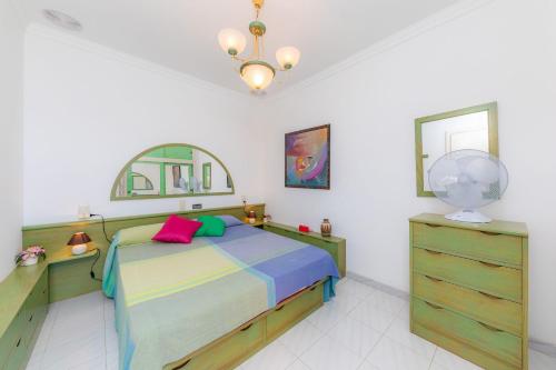 a bedroom with a bed and a mirror and a dresser at Ca Na Xisca in Sa Coma