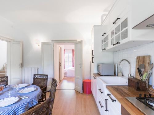 a white kitchen with a table and a sink at Wonderful Villa Botticelli in Cavaion Veronese