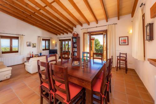a dining room with a wooden table and chairs at Cas Pobler in Manacor