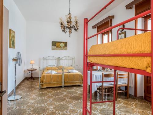 a bedroom with two bunk beds and a table at Villetta Lucia in Taviano