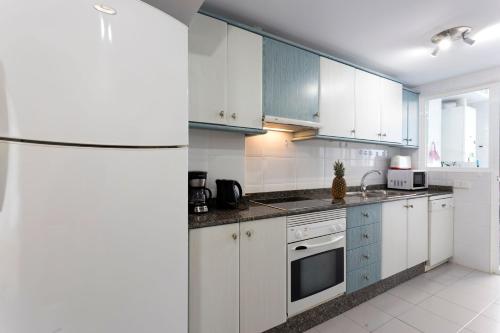 a kitchen with white cabinets and a refrigerator at Villa Jose in Palma de Mallorca