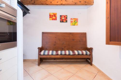 a bench in a kitchen with two pictures on the wall at Sa Fusteria in Sóller