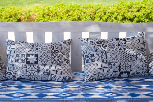 a white bench with pillows on top of it at Abatzer in Ciutadella