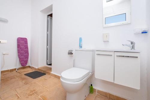 a bathroom with a toilet and a sink at Abatzer in Ciutadella