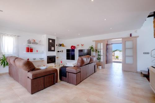 a living room with two chairs and a table at Abatzer in Ciutadella