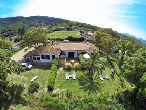 an aerial view of a house with chairs and trees at Appartamenti Le Querce App. Uva in Capoliveri