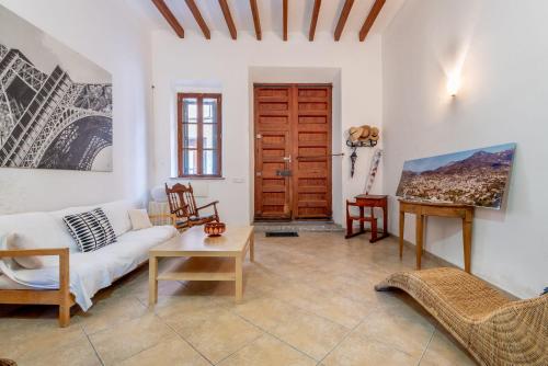 a living room with a couch and a table at Villa Can Got in Sóller
