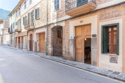 an empty street in an old town with buildings at Villa Can Got in Sóller