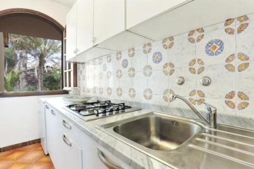 a kitchen with a sink and a stove top oven at Villa Artistica app.3/bilo4 (bilocale) in Capoliveri