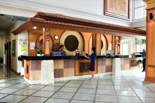 a woman standing at a counter in a restaurant at Lek Villa in North Pattaya