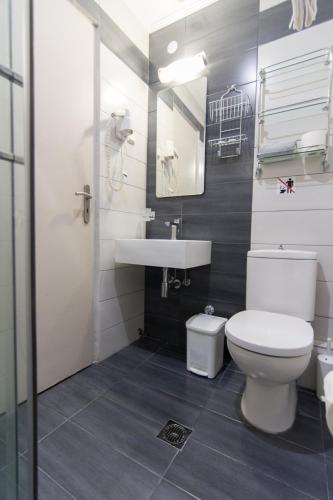 a bathroom with a toilet and a sink at San Nectarios in Parga