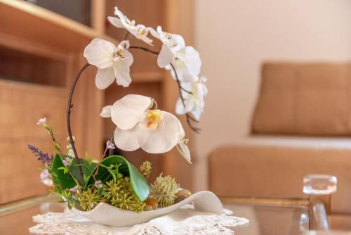 a vase filled with white flowers on a table at Solluna in Son Servera