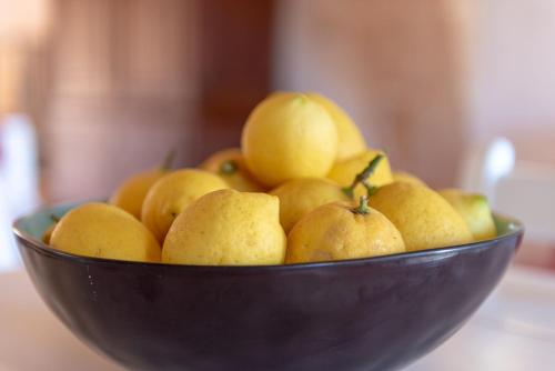 a bowl of yellow fruit on a table at Es Rafal Roig - Es Nord in Sant Llorenç des Cardassar