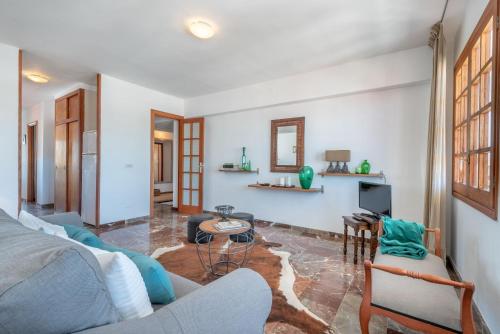 a living room with a couch and a tv at Bennassar 2 in Felanitx