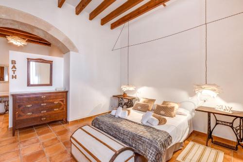 a bedroom with a bed and a table in a room at Finca Buniferri in Llucmajor