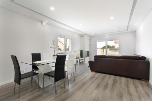 a living room with a table and a couch at A.V Holidays in Fernao Ferro