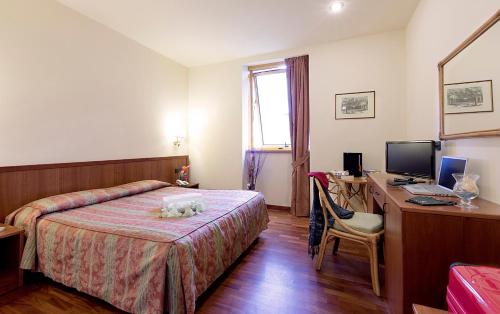 Postel nebo postele na pokoji v ubytování Hotel Tivoli
