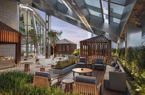 a lobby of a building with chairs and tables at Park Hyatt Shenzhen in Shenzhen