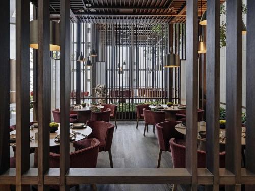 a restaurant with tables and chairs in a room at Park Hyatt Shenzhen in Shenzhen