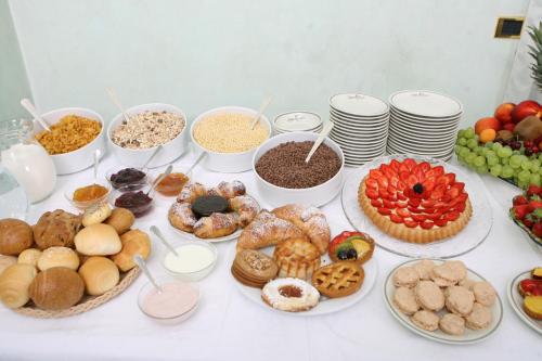 a table topped with lots of different types of food at Albergo Milano in Boario Terme