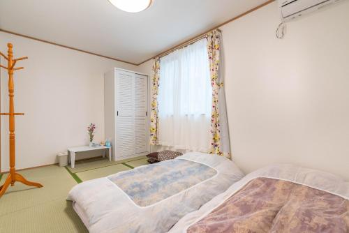 Postel nebo postele na pokoji v ubytování Travel Palace Miyuki