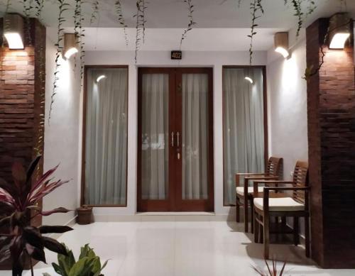 a living room with a door and a table and chairs at BatanTop Ubud guest house in Ubud