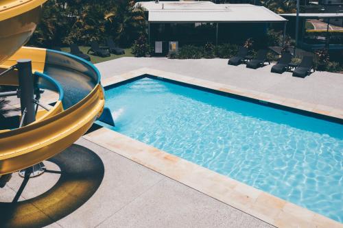 a swimming pool with a slide in a resort at Nobby Beach Holiday Village in Gold Coast