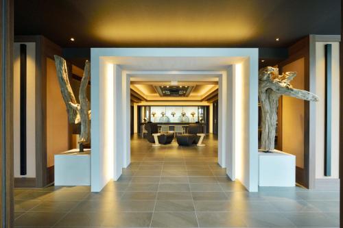 a hallway with white columns in a building at THE CHELSEA BREATH in Takamatsu
